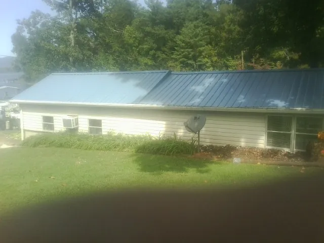 Blue metal roof running the length of a single story home in Claridge